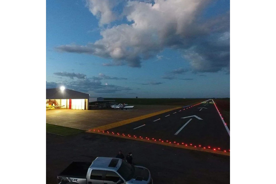 A supplied paved airfield-like scene with an aircraft in the distance